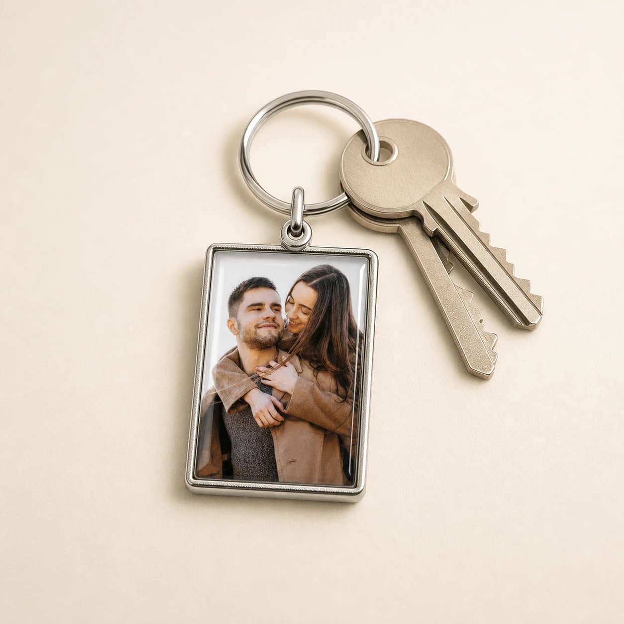 Personalised rectangular metal photo keyring in a studio setting